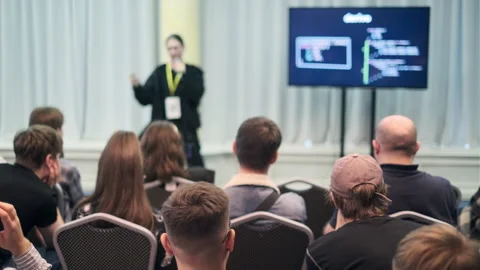 Speaker discussing programming concepts during technology seminar with audience Stock Footage 317338980