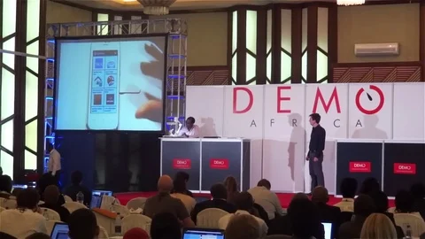 Speaker explains a smart phone app at Demo Africa conference Video stock 72577173