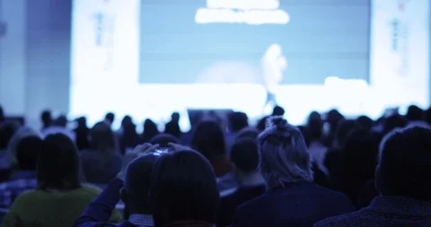 Speaker man on stage talking ans showing presentation on screen at auditorium. Stock Footage 120256930