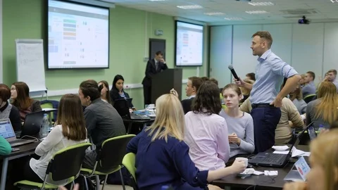 Speaker with microphone and large group of people are waiting for the results of Stock Footage 70932184