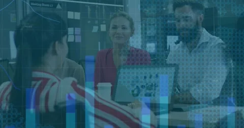 Speaker presenting and gesturing in business meeting, laptop showing charts, Stock Footage 332275659