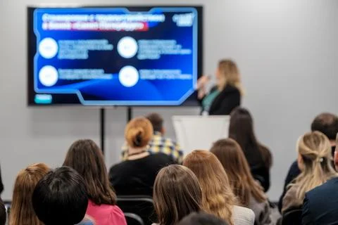 Speaker presenting to audience with digital screen in conference session Stock Photos