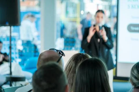 Speaker presenting to audience in a professional setting Stock Photos