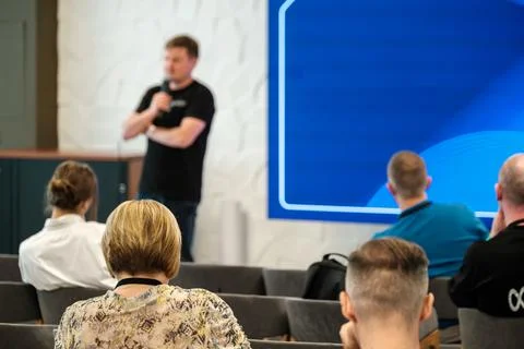 Speaker presenting to an audience in a professional workshop setting Stock Photos