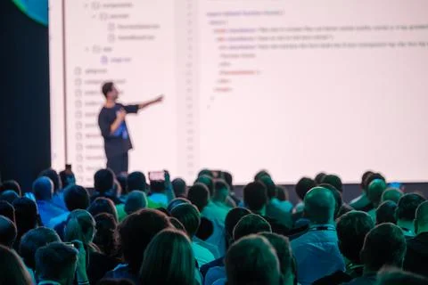 Speaker presenting code at a tech workshop to an engaged audience Stock Photos
