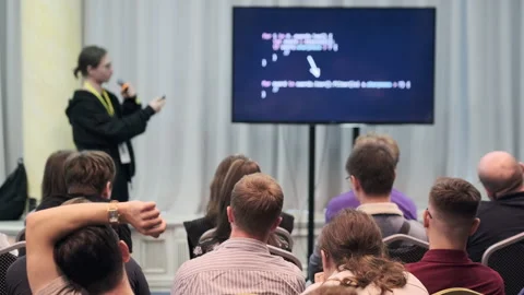 Speaker presenting slides to an audience during a professional seminar Stock Footage 317626717