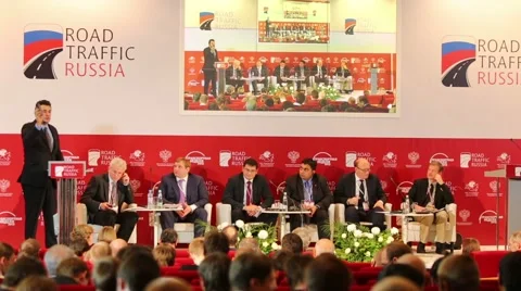 Speaker shows new device for voting on stage Stock Footage 40065516