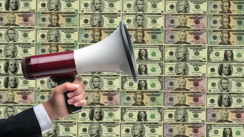 A speaker uses a megaphone to communicate insights on financial literacy, s.. Stockbeeldmateriaal 283936492