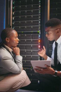 Speaking, team or engineer with tablet by server rack, upgrade plan or mainframe Stock Photos