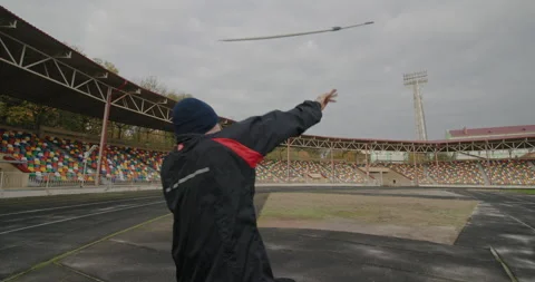 Spear throwing training Paralympian man with defective legs sitting in a Stock Footage 154255937