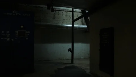 Special agent in camouflage goes through the building with a weapon. Fully Stock Footage 107326360