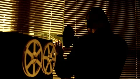 The special agent overhears the conversation with a directional microphone Stockbeeldmateriaal 130106626