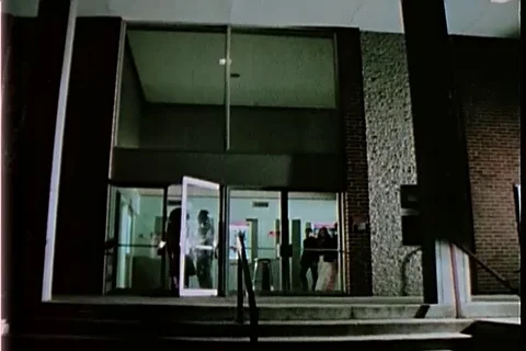 Special agents waits out side the movie theater - 1973 Stock Footage 107698223