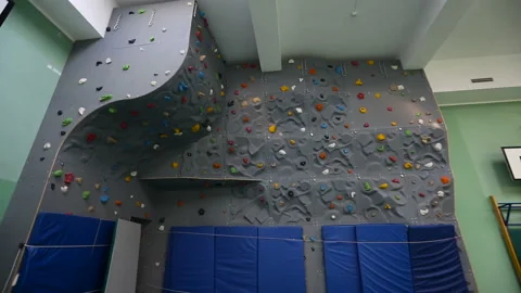 Special climbing wall for training in the school of future climbers. Wall for Stock Footage 93895969
