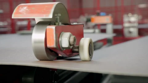 A special device evenly cuts the raw material. Industry. Enterprise for the Stock Footage 197410890
