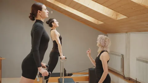 Special exercise programs concept. Pilates lesson on chair, side view of blond Stock Footage 229437687