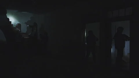 Special forces armed squad raiding a dark building at night Stock Footage 330566925