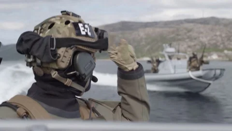 Special Forces Commander Gives commands to a neighboring combat boat Stock Footage 120947998
