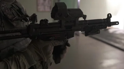 The Special Forces man is loading his weapon. Loads ammunition into the clip. Stock Footage 239358702