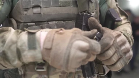 The Special Forces man is loading his weapon. Loads ammunition into the clip. Stock Footage 239359063