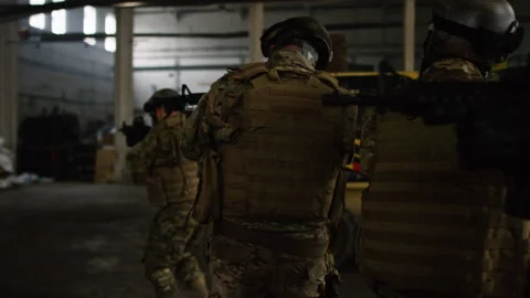 Special forces military team points guns trying to find hiding suspects in stora Stock Footage 199458513