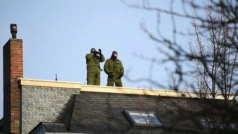 Special forces sniper securing a perimeter from a rooftop Video stock 101652620