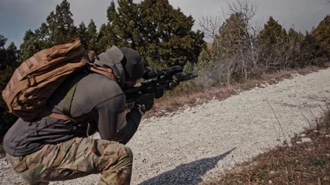 Special forces soldier during a tactical exit fires from an AR rifle w Stock Footage 261280048