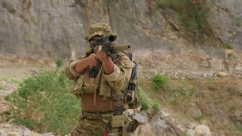 Special forces soldier in full tactical gear aims a sniper rifle Stock Footage 342619455