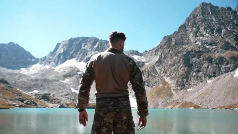 A special forces soldier in a multicam climbed to the top of the mountain Stock Footage 138444407