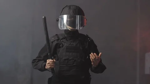 Special forces soldier threatens crowd of protesters with baton or stick Stock Footage 125550048
