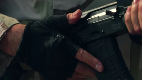 Special forces soldier with weapon. Pulling the charging handle Stock Footage 197515622