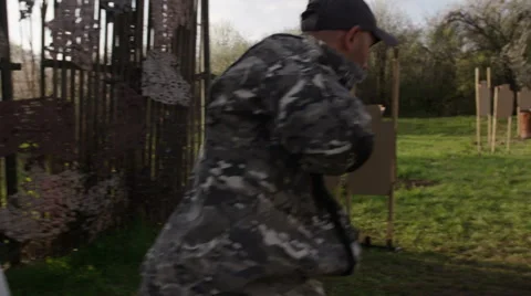 Special forces solider exercise shooting a gun while running at military camp Stock Footage 64363109