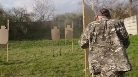 Special forces solider exercise shooting a gun while running at military camp Stock Footage 64378657