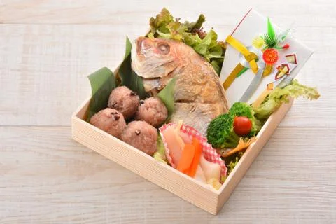 Special gift box with fried snapper fish, broccoli, lettuce and rice ball Stock Photos