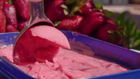 The special ice-cream spoon is scooping a delicious fresh strawberry ice cream Stock Footage 287855818