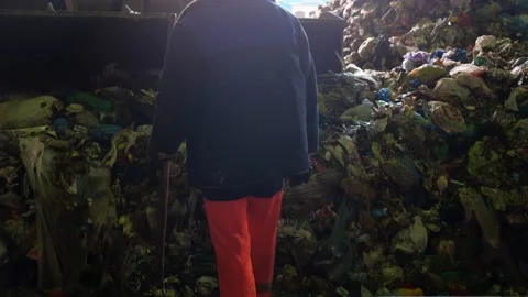 Special machine with bucket heaps pile of unsorted waste. Garbage sorter worker. 動画素材 220690266