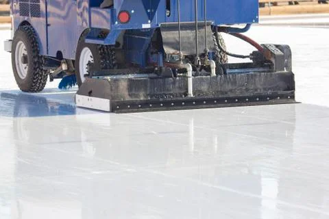 Special machine for cleaning ice on an ice rink at work. Transport industry Stock Photos