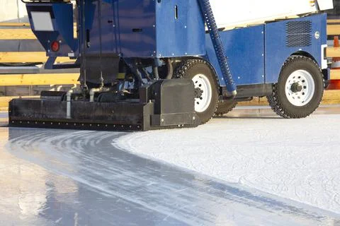 Special machine for cleaning ice on an ice rink at work. Transport industry Stock Photos