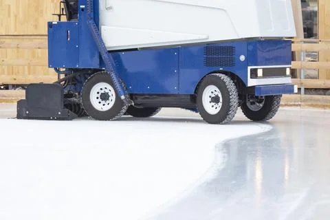 Special machine for cleaning ice on an ice rink at work. Transport industry Stock Photos