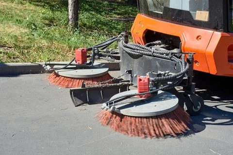 A special machine sweeps city paths Stock Photos