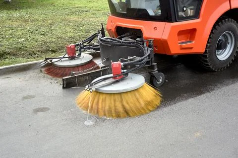 A special machine sweeps city paths Stock Photos