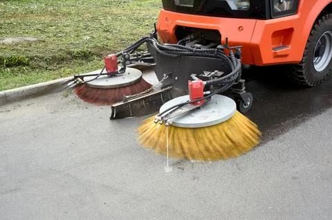 A special machine sweeps city paths Stock Photos