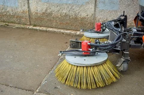 A special machine sweeps city paths Stock Photos