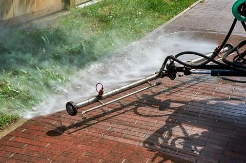 A special machine washes city paths and roads with water Stock Photos