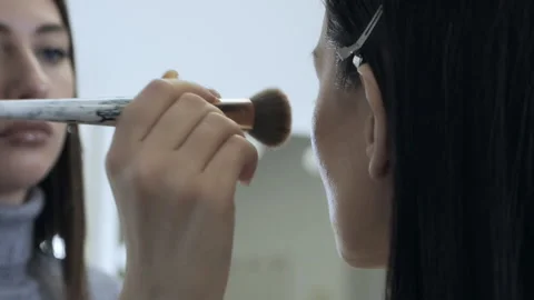 With a special makeup brush, a professional make-up artist makes makeup for the Stock Footage 167181194