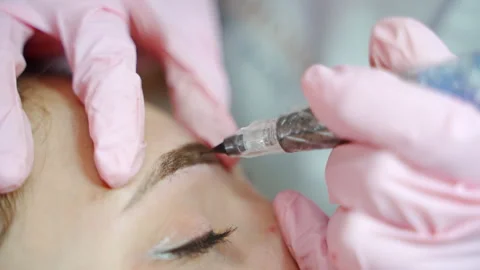 Special needle tattoo machine is used for permanent make up. Stock Footage 294981406
