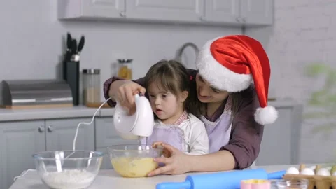 Special needs kid helps mom to cook xmas biscuit Video stock 98665085