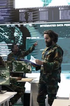 Special operations engineer analyzing mission case files before briefing crew Stock Photos