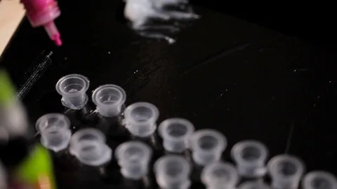 A special paint for doing the tattoo.Preparation of master tattoo artist to work Stock Footage 73587895