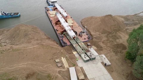 Special transportation platform on wheels, drives up to a barge. Stock Footage 124245318